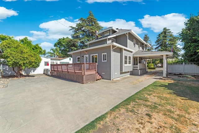 view of property exterior with fence and a deck