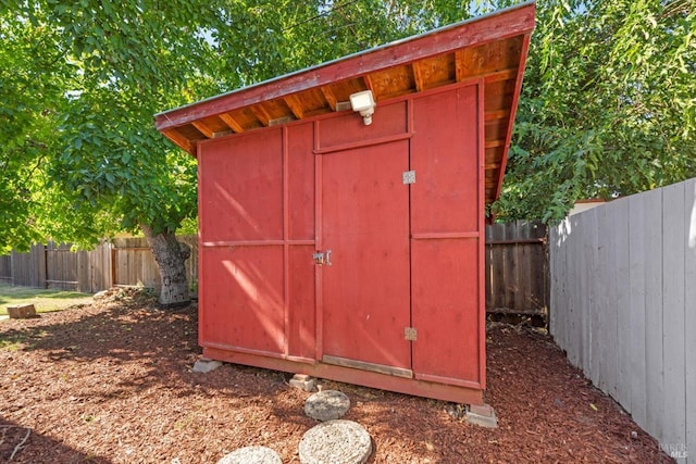 view of shed with a fenced backyard