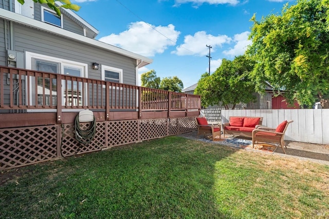 view of yard with fence, outdoor lounge area, and a wooden deck