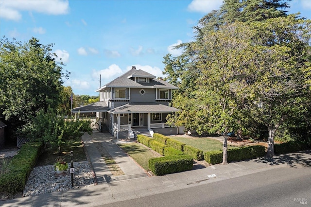 traditional style home featuring driveway and a porch