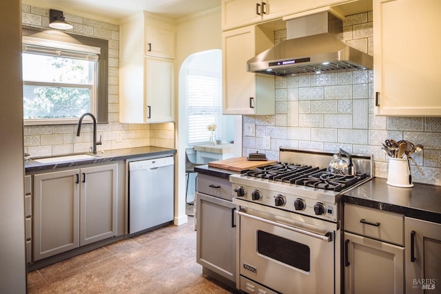 kitchen featuring dark countertops, designer stove, dishwasher, and exhaust hood