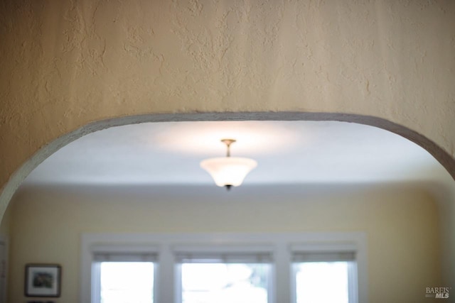 interior details with arched walkways and a textured wall