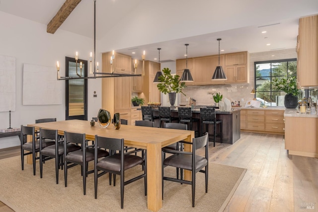 dining room featuring high vaulted ceiling, beamed ceiling, light wood-type flooring, and recessed lighting