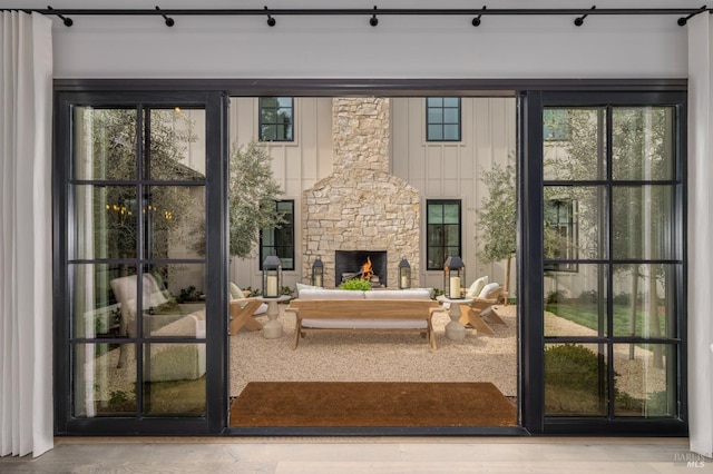 doorway with a healthy amount of sunlight and a stone fireplace