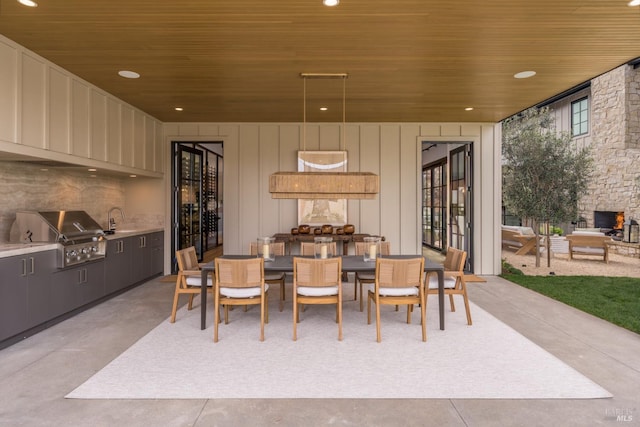 dining room featuring concrete flooring, wood ceiling, and recessed lighting