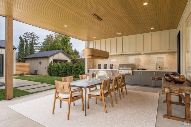 view of patio with outdoor dining space, an outbuilding, area for grilling, and fence