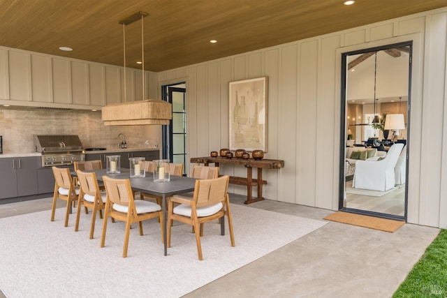 dining room with wood ceiling, concrete floors, and recessed lighting