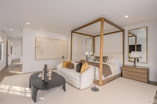 bedroom with baseboards, wood finished floors, and recessed lighting