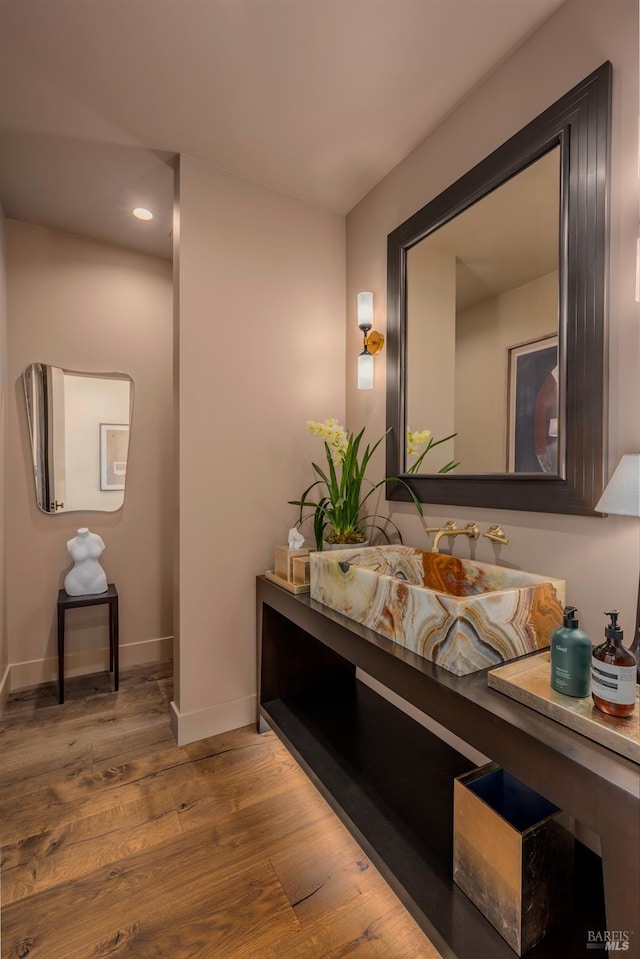 bathroom featuring recessed lighting, wood finished floors, and baseboards