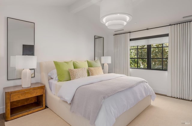 carpeted bedroom with visible vents and lofted ceiling with beams