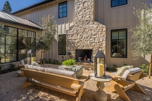 view of patio with an outdoor living space with a fireplace