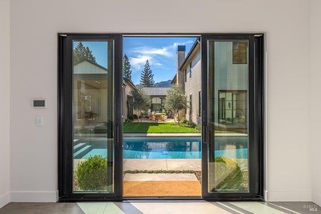 doorway featuring baseboards