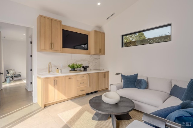 living area featuring visible vents, vaulted ceiling, and recessed lighting