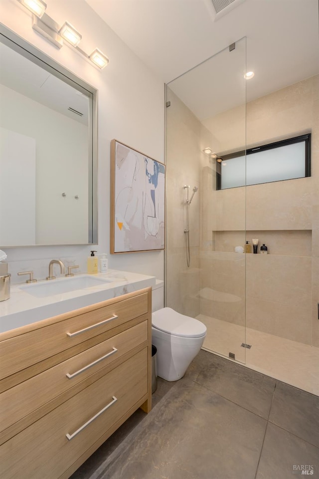 bathroom with toilet, a walk in shower, and vanity