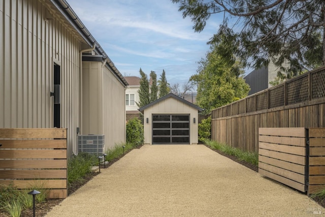 detached garage with driveway and fence