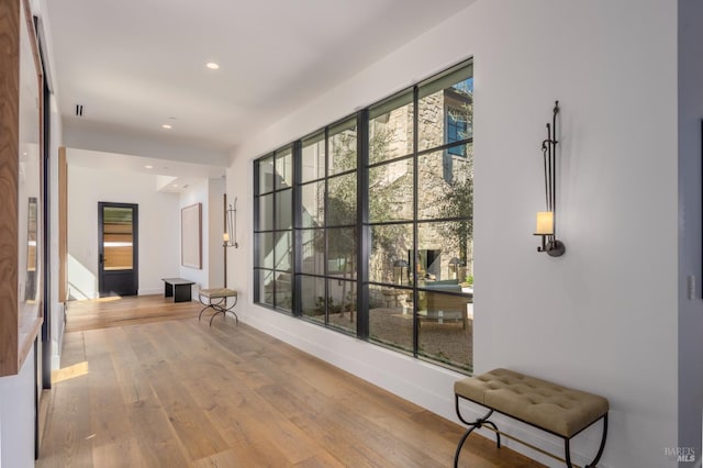 hallway with recessed lighting, wood finished floors, and baseboards