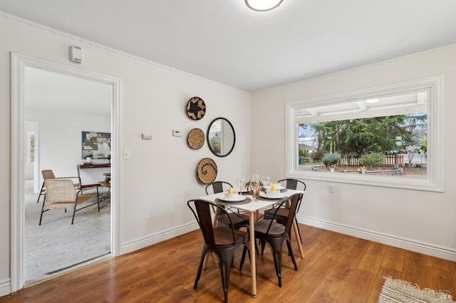 dining area with hardwood / wood-style flooring and baseboards