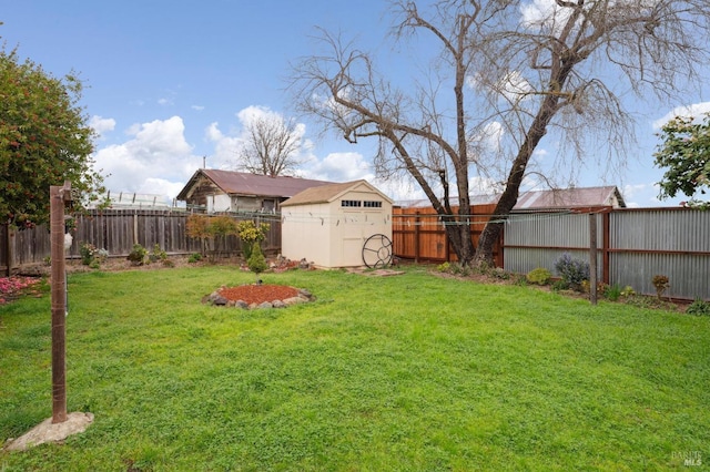 view of yard featuring a fenced backyard, a storage unit, and an outdoor structure