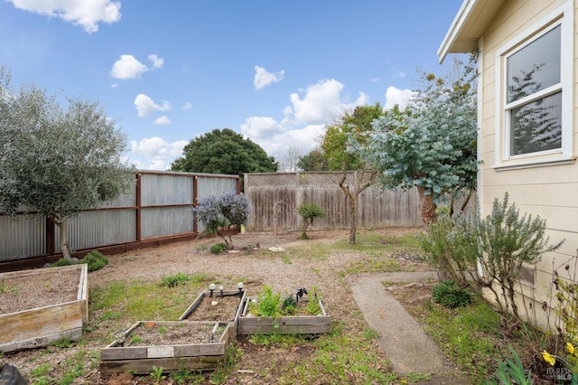 view of yard with a fenced backyard and a vegetable garden