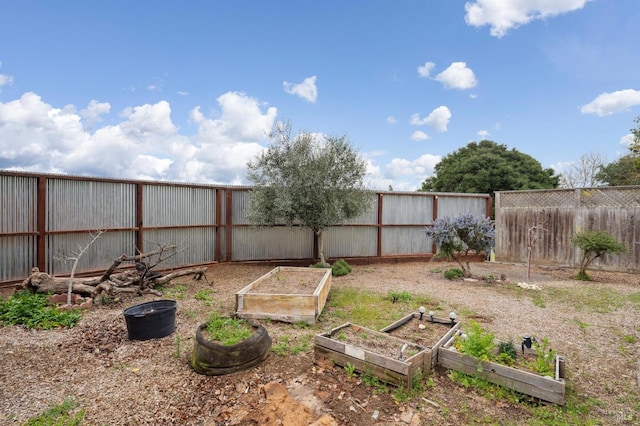 view of yard with a fenced backyard and a vegetable garden