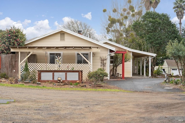 view of front of property with an attached carport and driveway