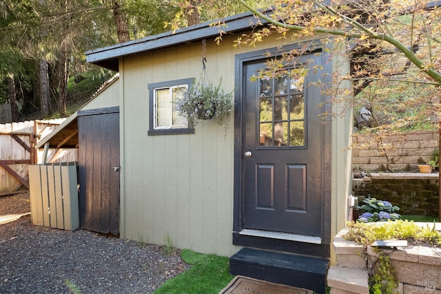 doorway to property featuring fence