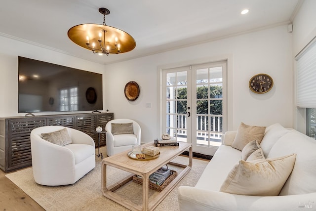 living room featuring a notable chandelier, recessed lighting, wood finished floors, french doors, and crown molding