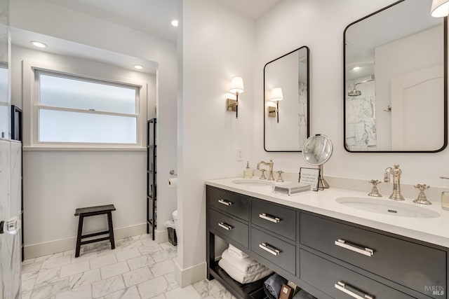 full bathroom with marble finish floor, double vanity, recessed lighting, a sink, and baseboards