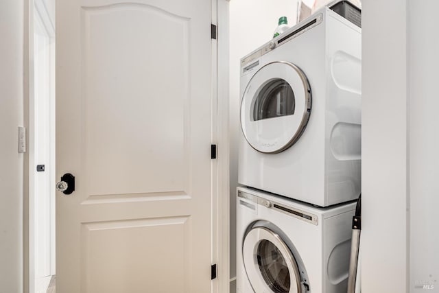 laundry area featuring stacked washer and dryer and laundry area