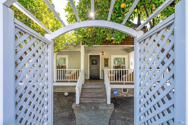 view of exterior entry featuring a porch