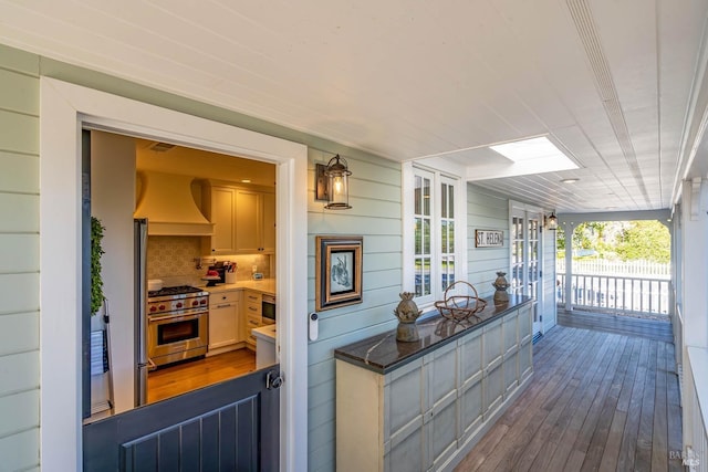 wooden terrace featuring covered porch