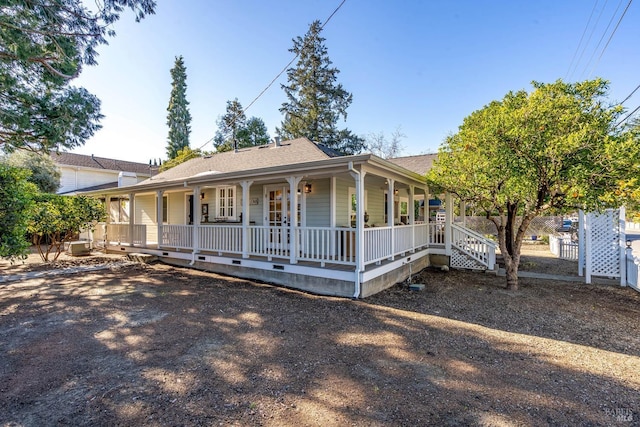 view of front of home with a porch and roof with shingles