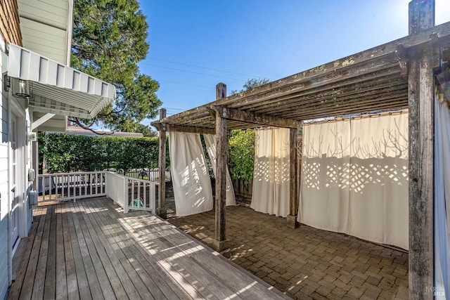 wooden deck with a patio and a pergola