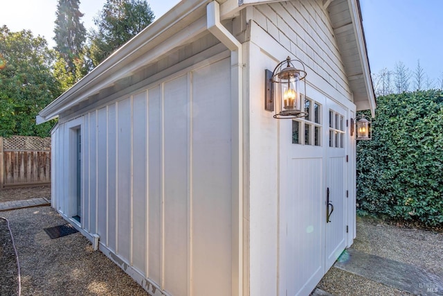 view of outbuilding featuring fence