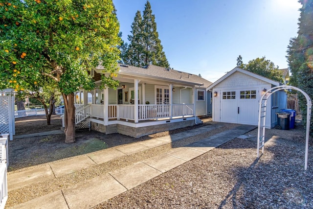 ranch-style home with covered porch, a garage, an outdoor structure, fence, and concrete driveway