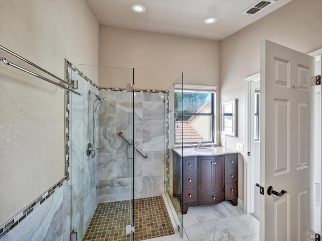 full bathroom with a stall shower, vanity, visible vents, and recessed lighting