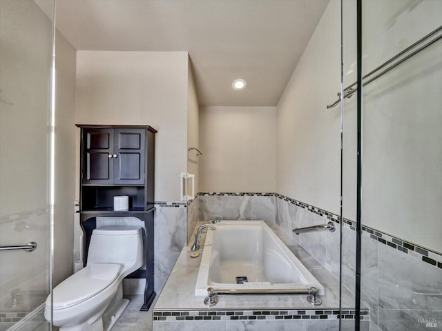 full bathroom featuring toilet, a garden tub, walk in shower, and tile walls