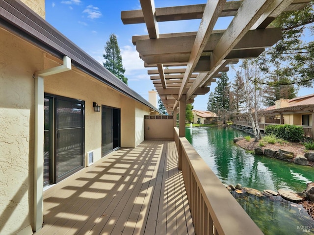 balcony with a water view and a pergola