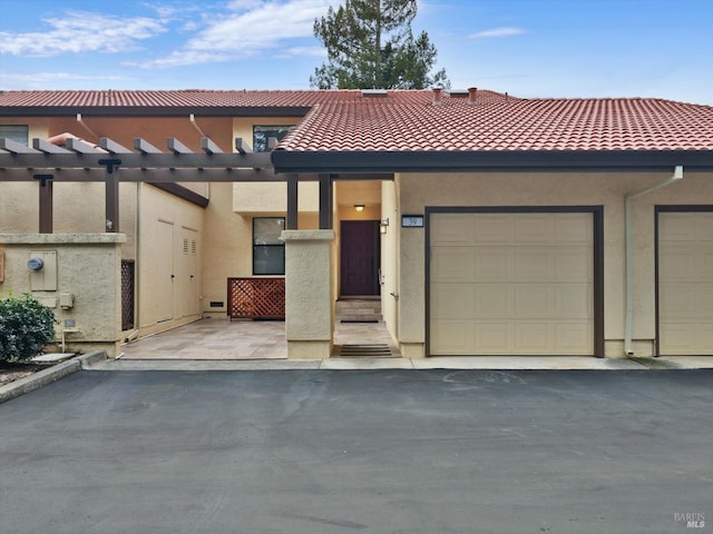 view of property with a tile roof and stucco siding