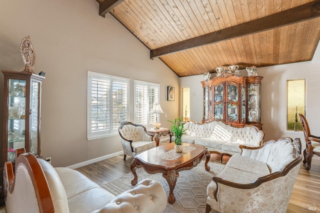 living area with beam ceiling, wooden ceiling, and wood finished floors