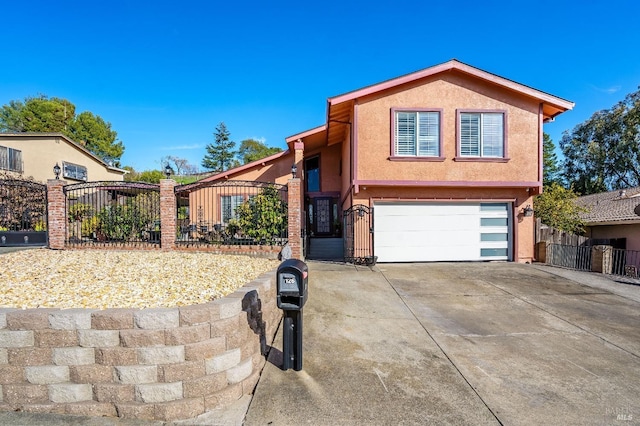 view of front of home featuring a garage, driveway, fence, and stucco siding