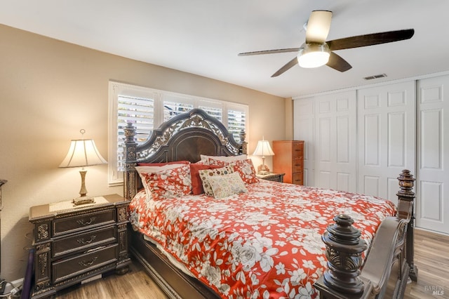 bedroom with a ceiling fan, a closet, visible vents, and light wood finished floors