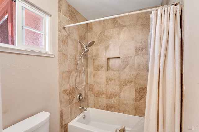 bathroom with toilet and shower / bath combo