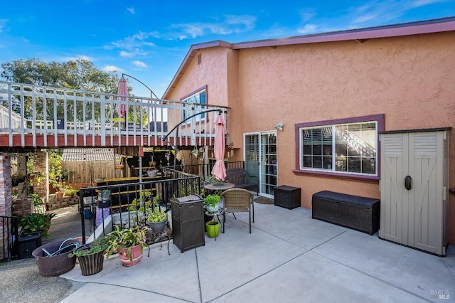 view of patio / terrace featuring fence and a wooden deck