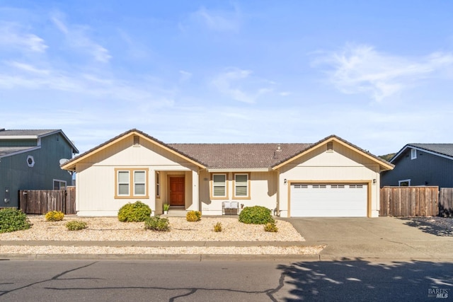 single story home with an attached garage, a tile roof, fence, and concrete driveway