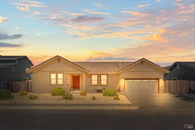 single story home featuring a garage, fence, concrete driveway, and a tiled roof