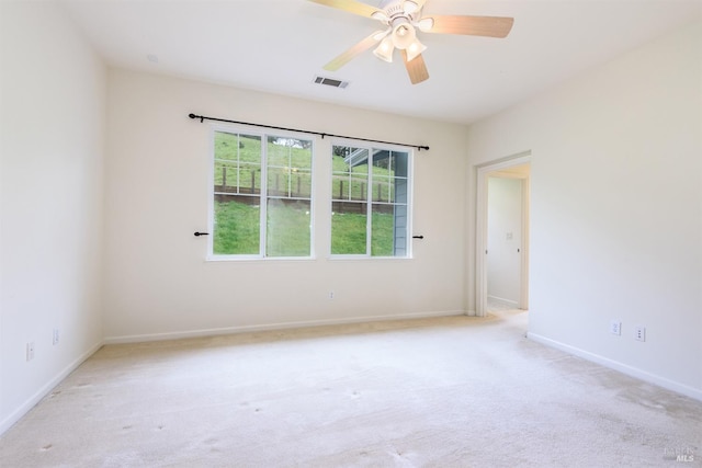 unfurnished room featuring baseboards, visible vents, ceiling fan, and carpet flooring