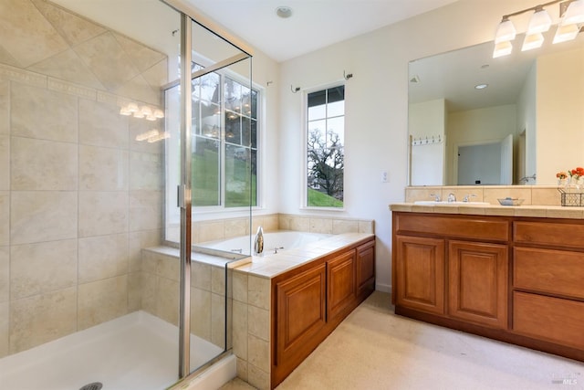 full bathroom featuring a garden tub, a shower stall, and vanity