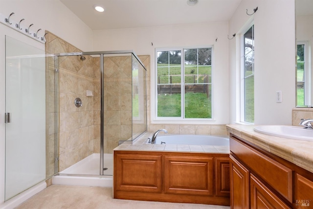 bathroom featuring a stall shower, a garden tub, vanity, and recessed lighting