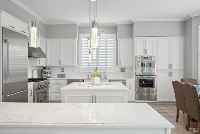 kitchen featuring premium appliances, a center island, a warming drawer, light tile patterned flooring, and light stone countertops